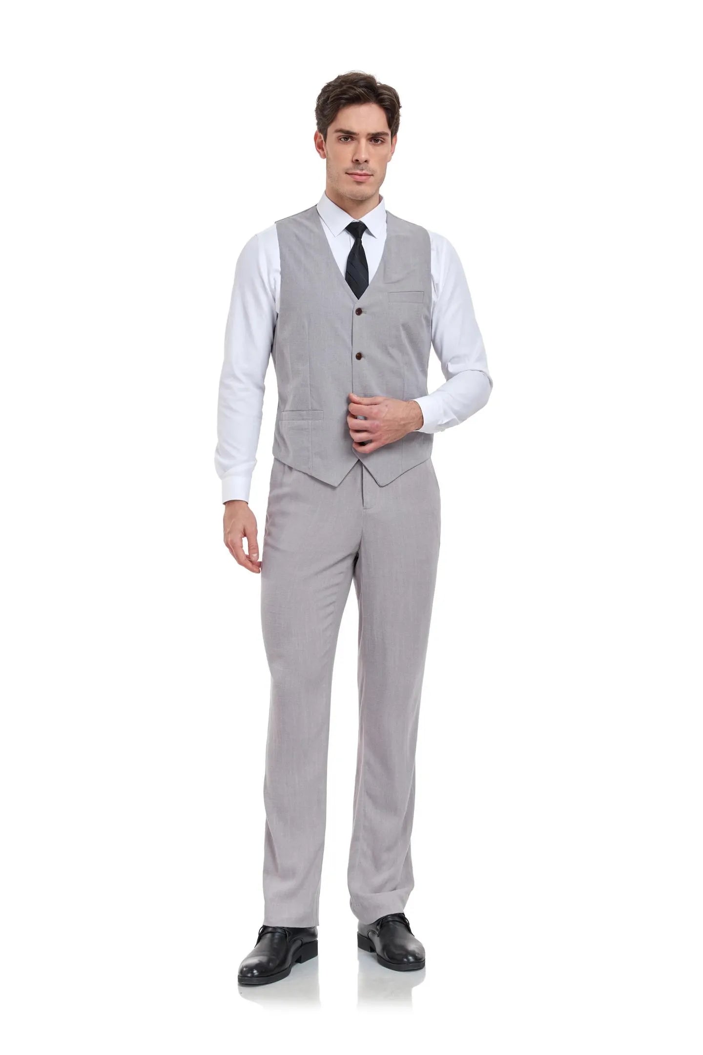 Man in grey linen 2 piece slim fit suit with V-neck vest and trousers, paired with white shirt and tie for summer weddings.