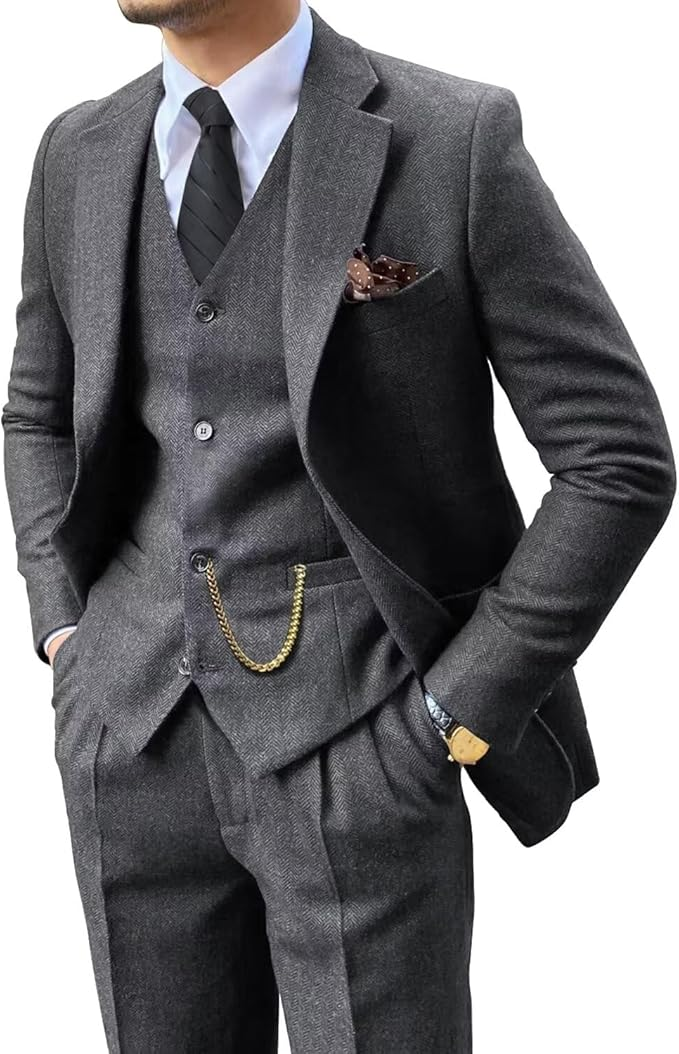 angled upper body close-up of slim fit grey herringbone suit for men with vest and tie