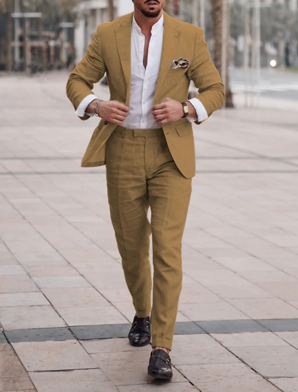 Man pairing brown linen pants with matching blazer and white shirt