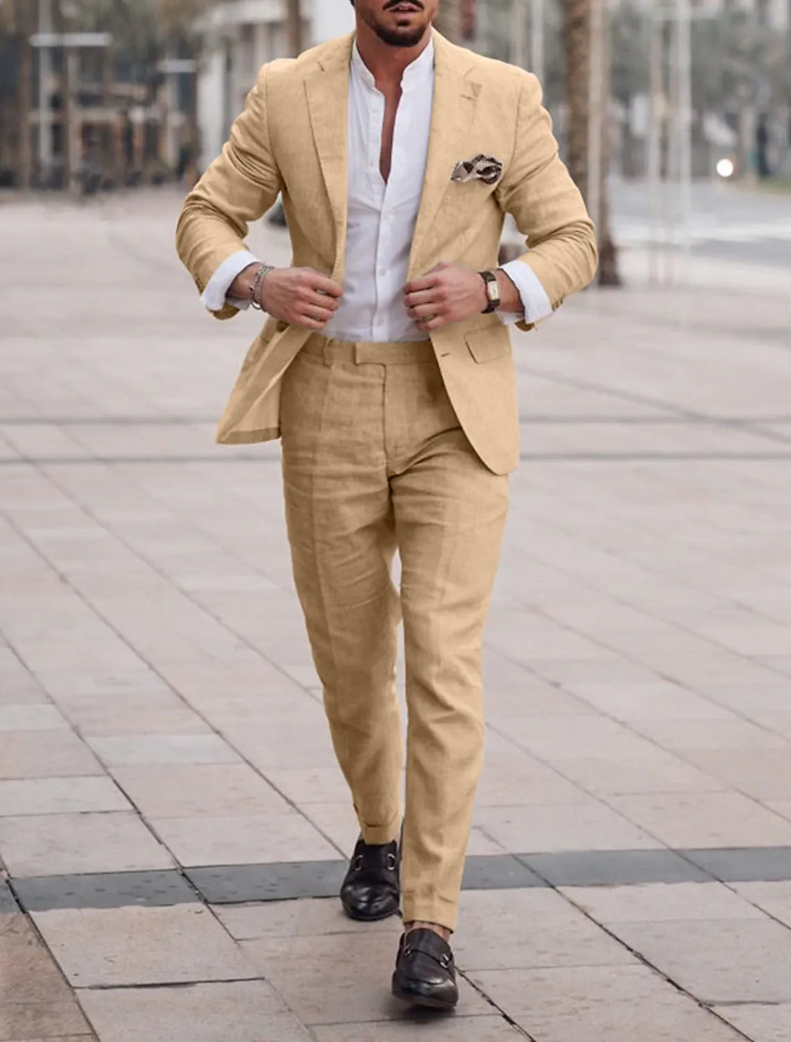 Model walking in khaki two-piece summer linen suit with black loafers