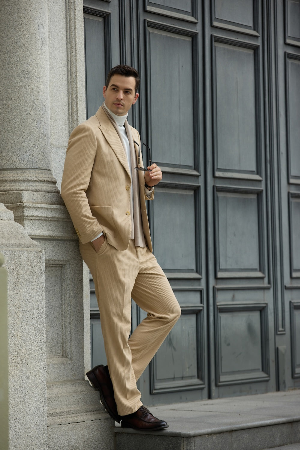 Side pose of man in beige corduroy suit – relaxed styling with vintage winter appeal