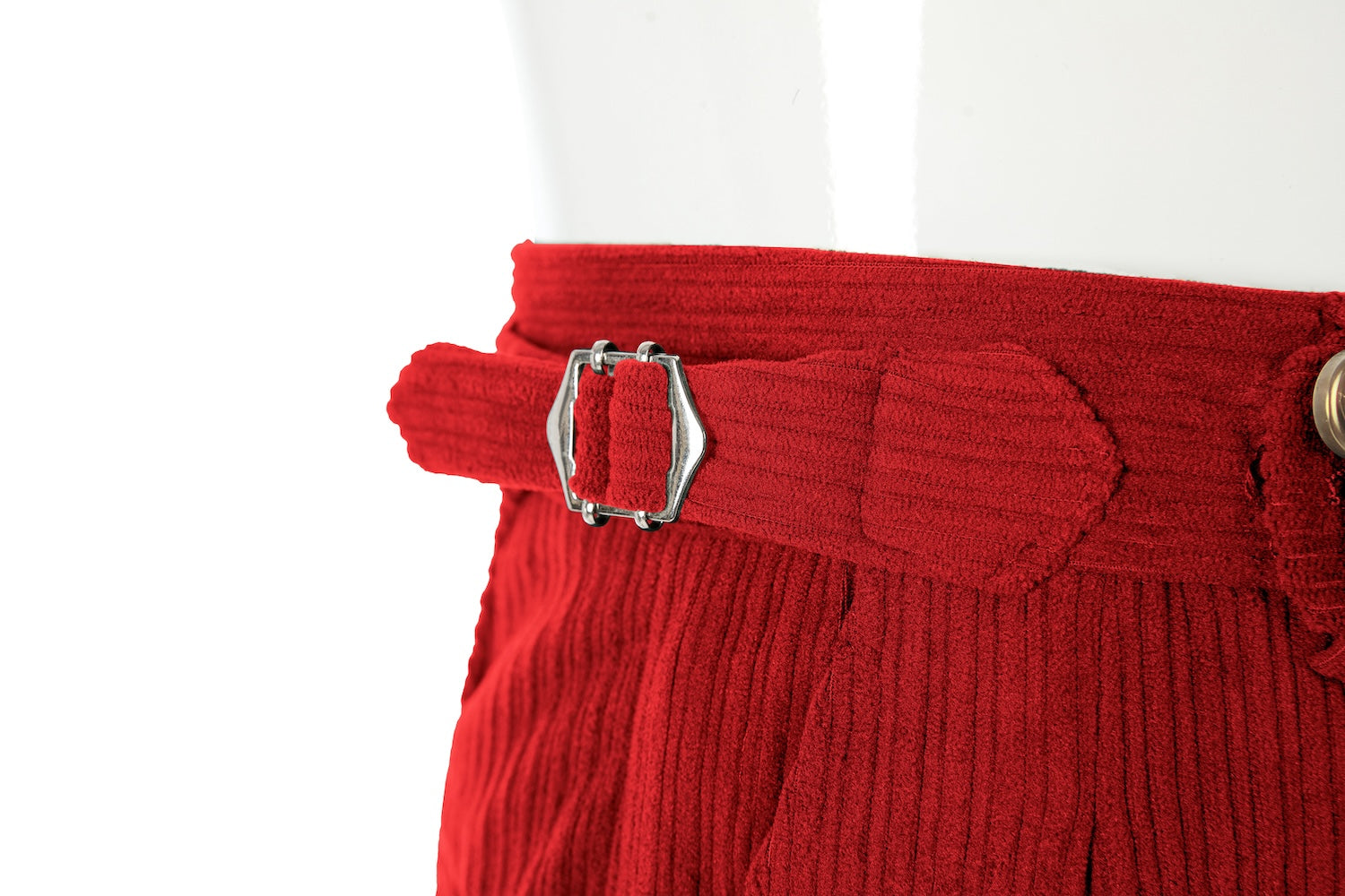Waistband close-up of men's red corduroy pants – button closure and belt loops