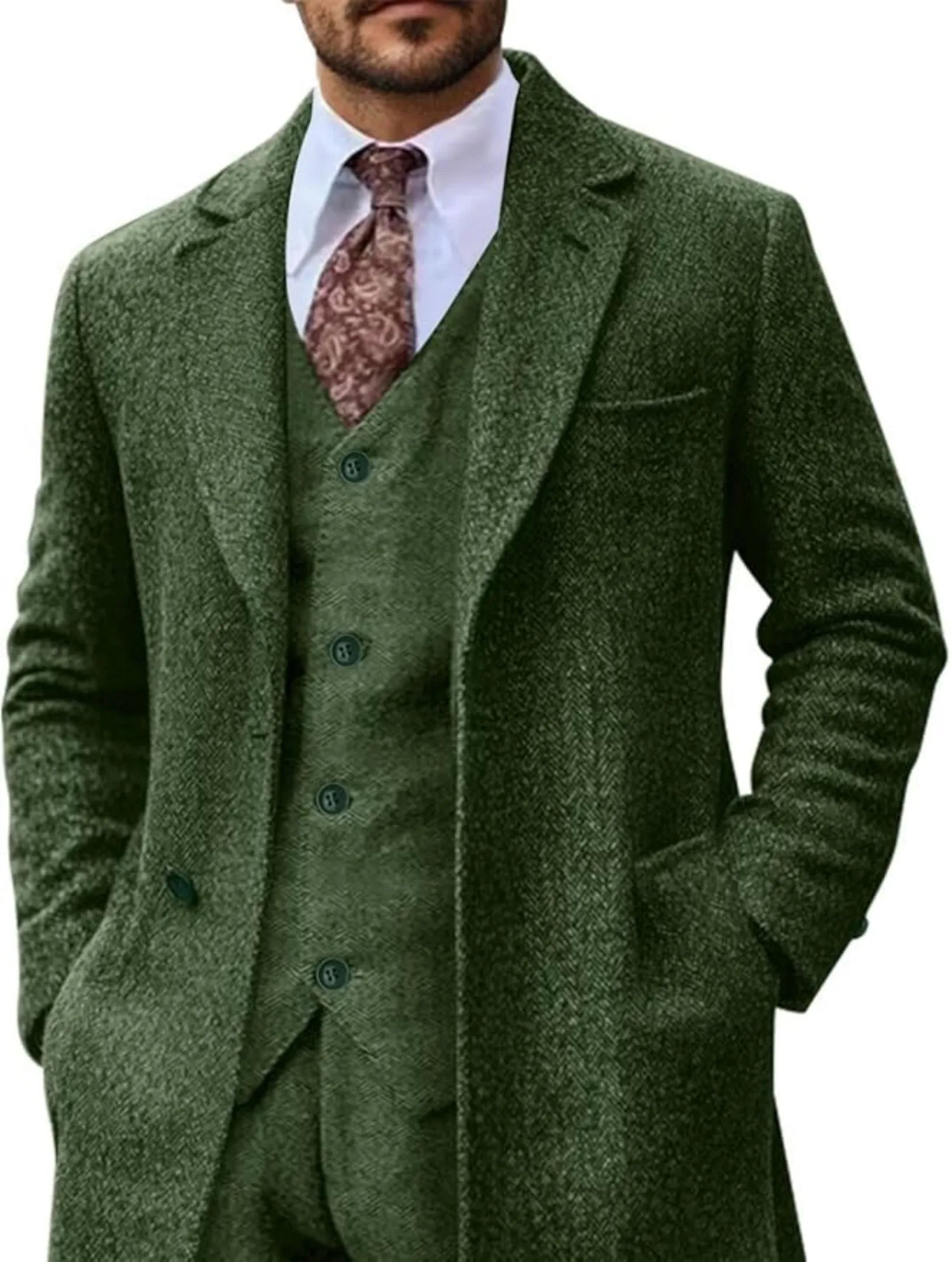 man wearing green retro herringbone 3-piece suit with long blazer, white shirt, paisley tie, business-formal look.