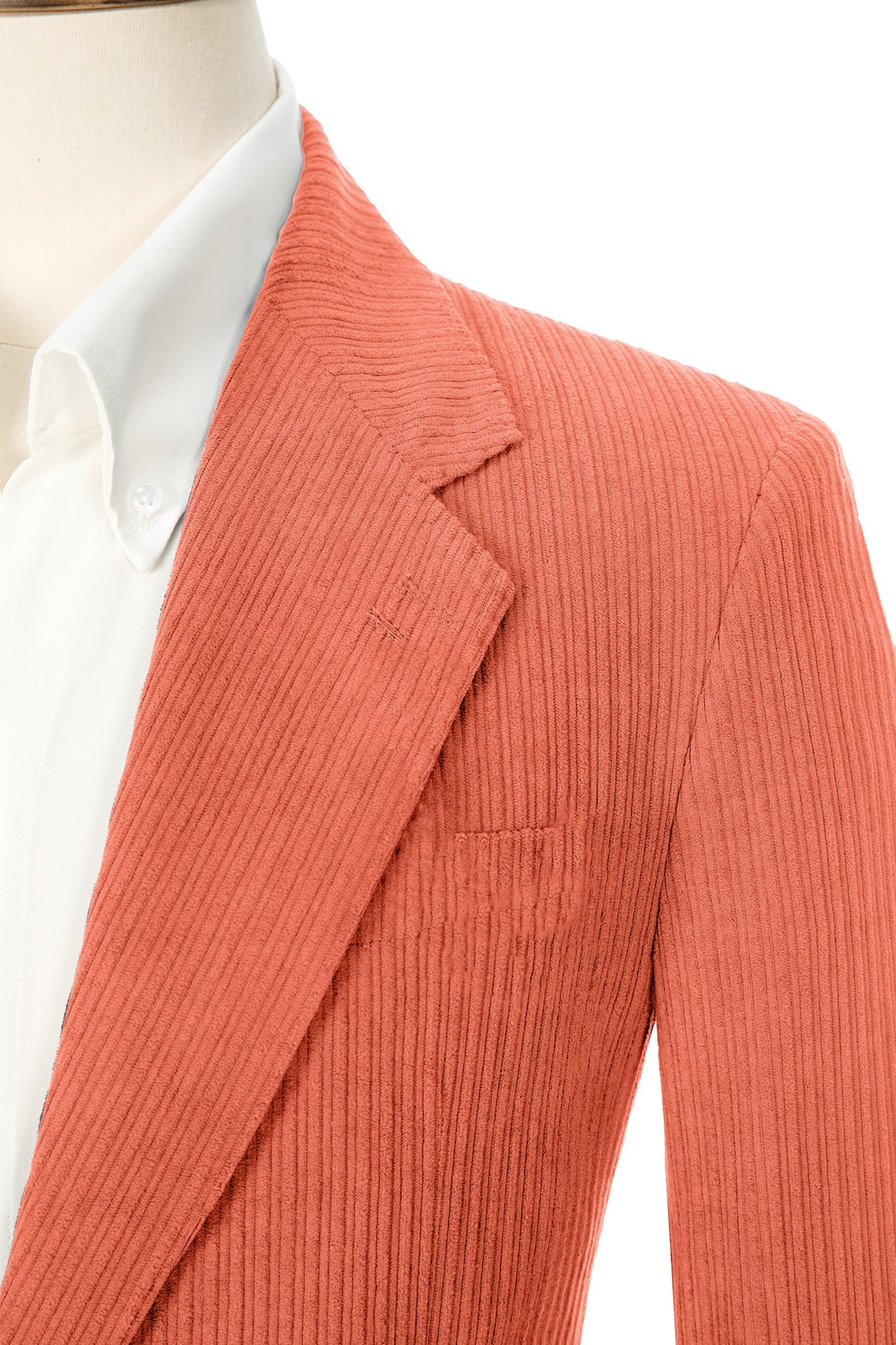 Close-up of coral corduroy prom blazer lapel – textured fabric, elegant cut