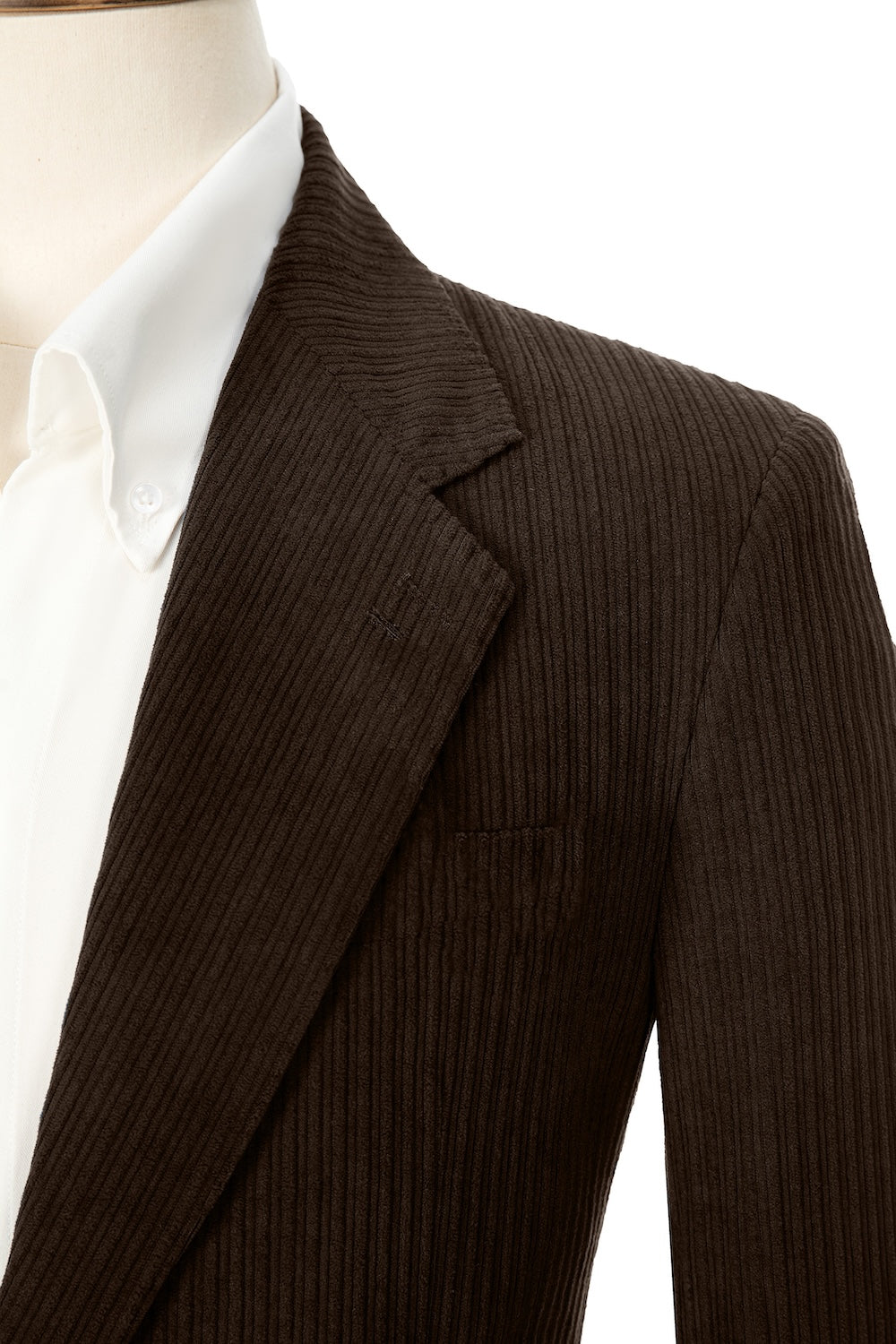 Close-up of dark coffee corduroy prom blazer lapel – textured fabric, elegant cut