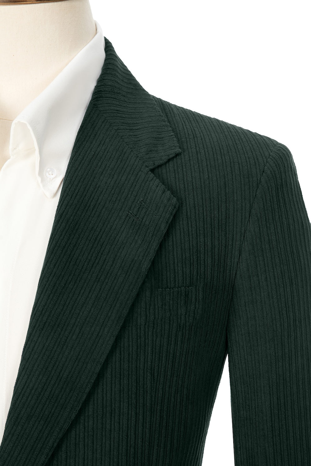 Close-up of dark green corduroy prom blazer lapel – textured fabric, elegant cut