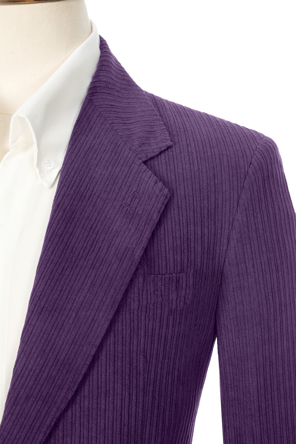Close-up of dark purple corduroy prom blazer lapel – textured fabric, elegant cut