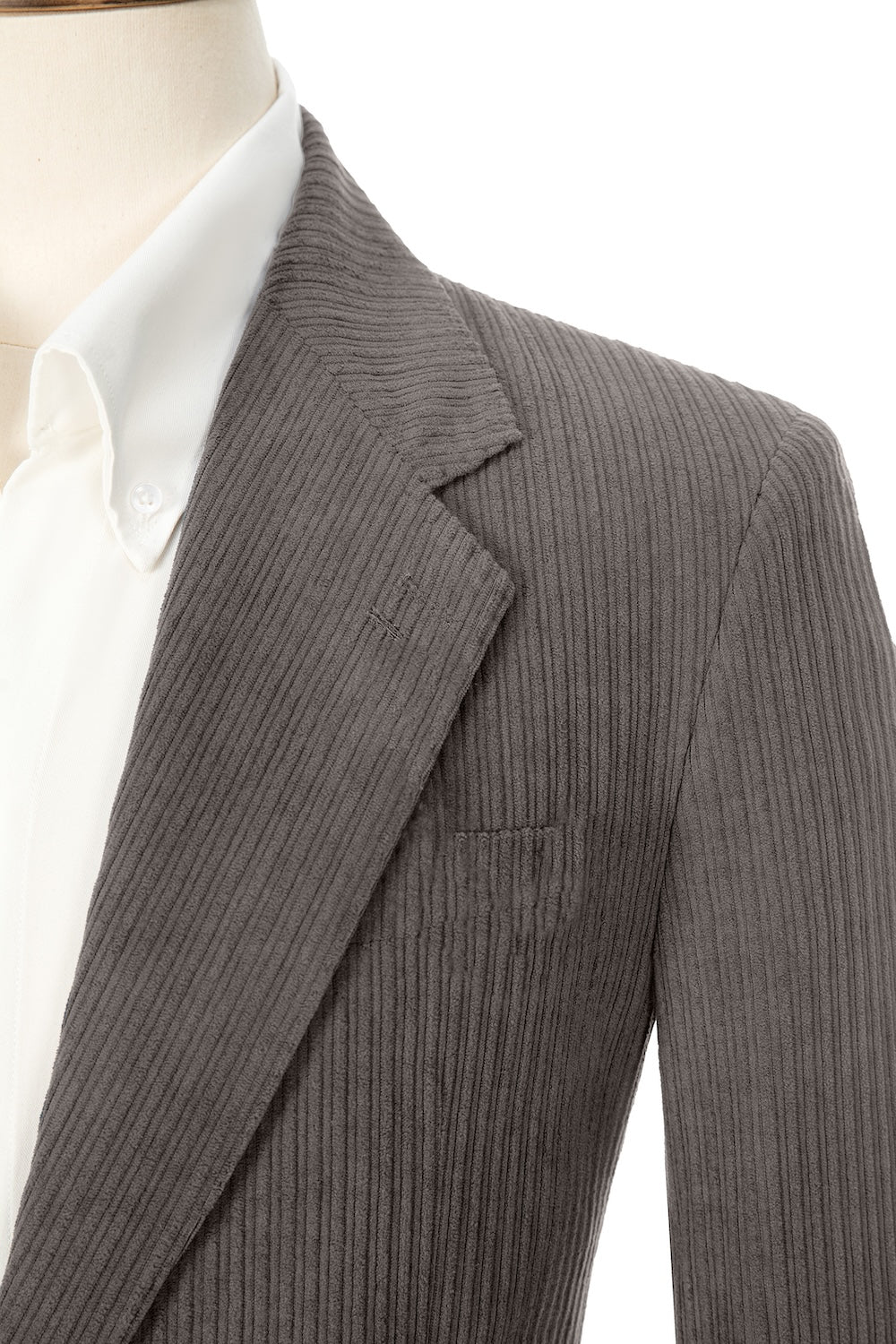 Close-up of grey corduroy prom blazer lapel – textured fabric, elegant cut