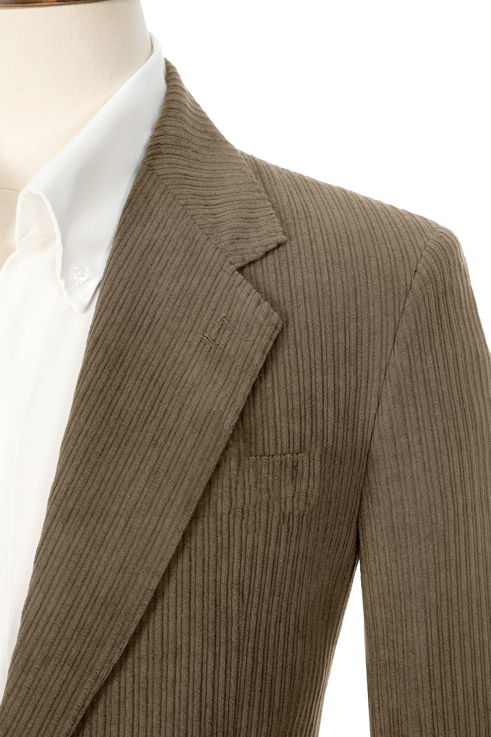 Close-up of light brown corduroy prom blazer lapel – textured fabric, elegant cut