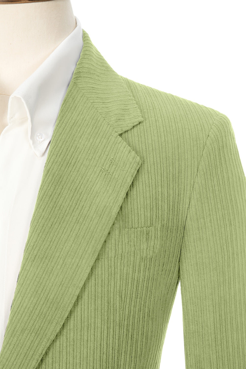 Close-up of light green corduroy prom blazer lapel – textured fabric, elegant cut