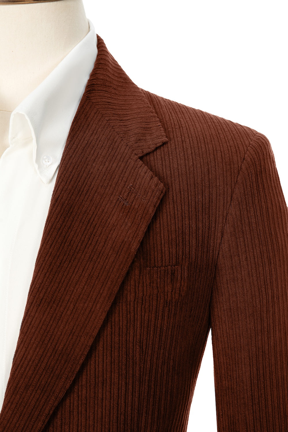 Close-up of light wine red corduroy prom blazer lapel – textured fabric, elegant cut