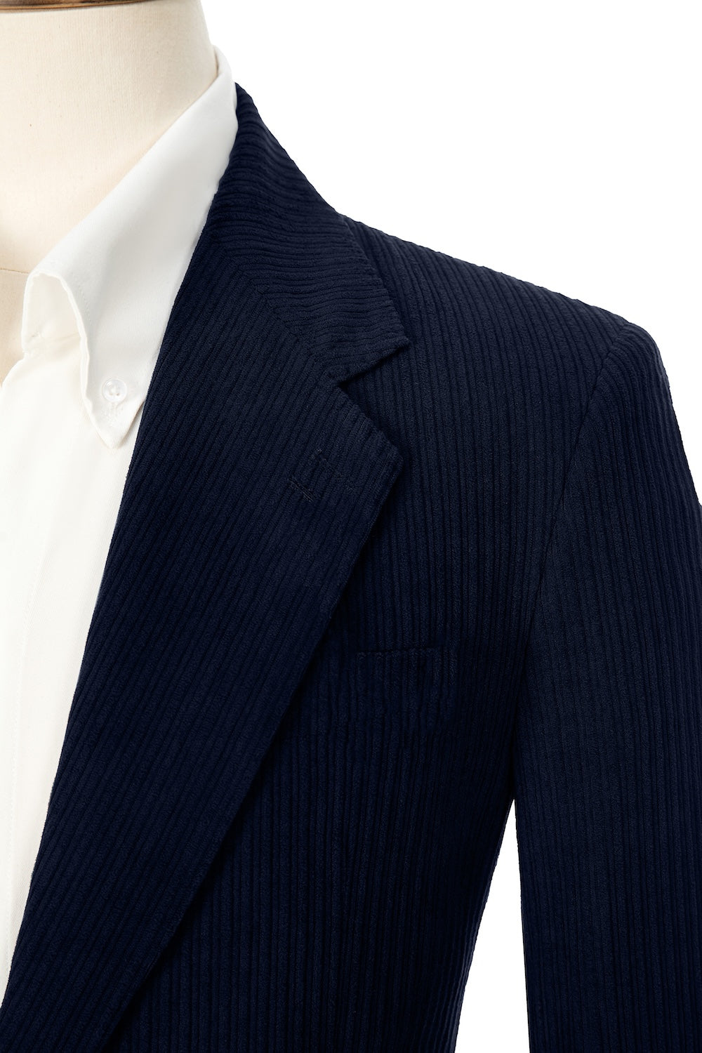 Close-up of navy corduroy prom blazer lapel – textured fabric, elegant cut