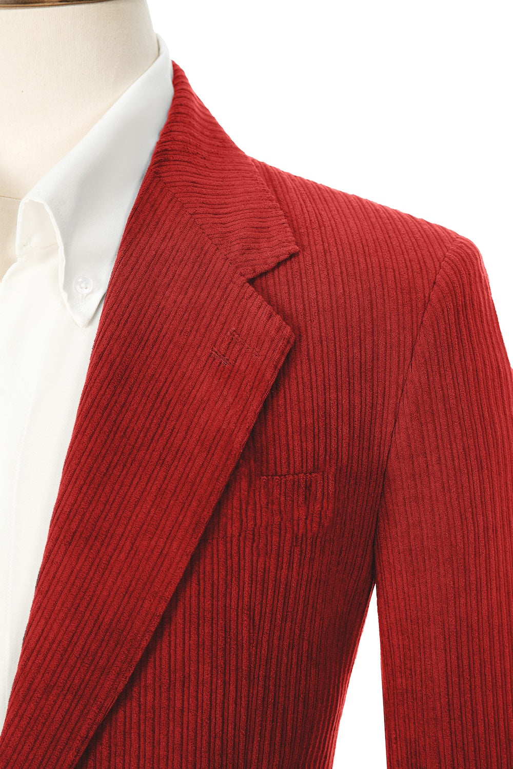 Close-up of red corduroy prom blazer lapel – textured fabric, elegant cut