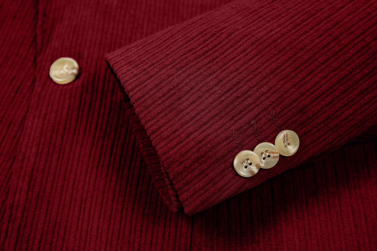 Detail of blazer sleeve in retro red corduroy – buttoned cuff with ridged finish