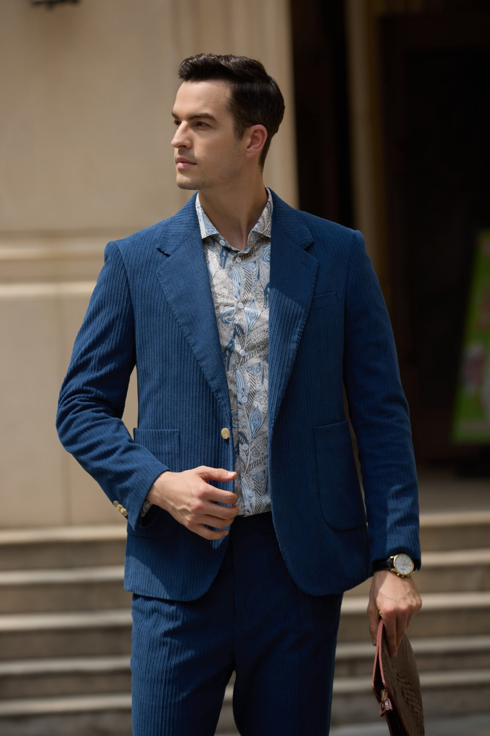 Close-up of men's royal blue corduroy blazer – peak lapel design styled with floral shirt for prom
