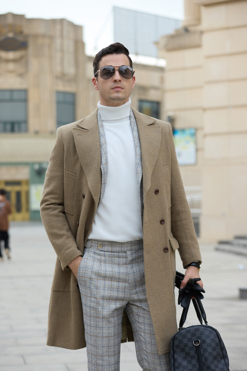 Close-up of the khaki wool overcoat for men – styled with gloves and watch