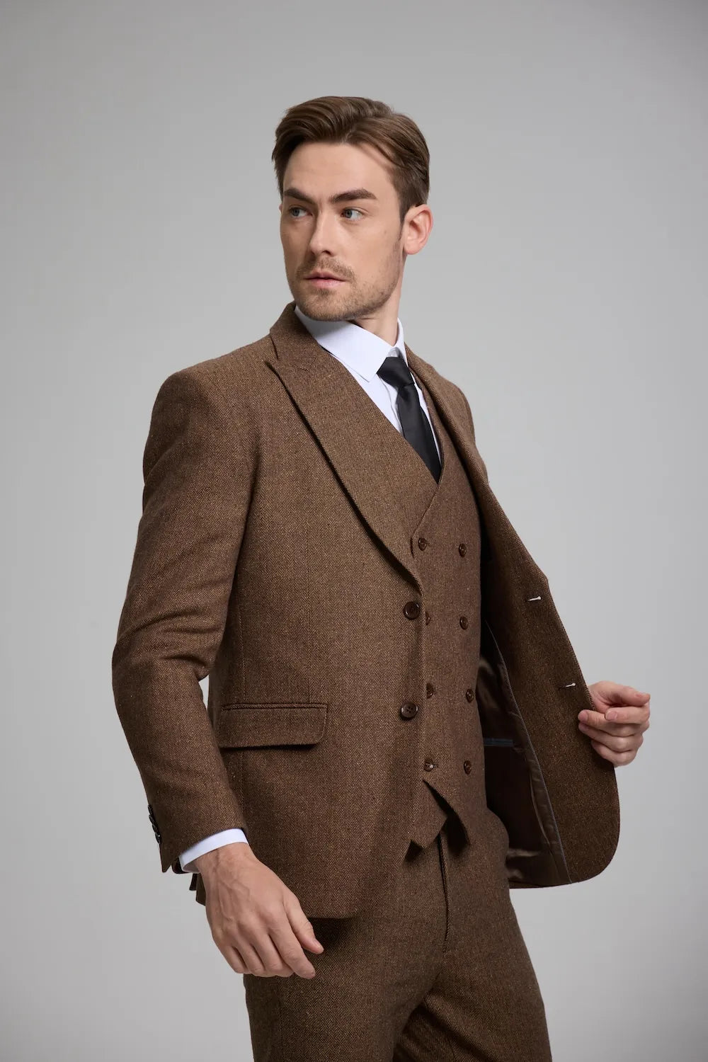 Side view of a brown Versatile Herringbone 3-Piece Suit for Men, showcasing sharp tailoring and a modern fit.