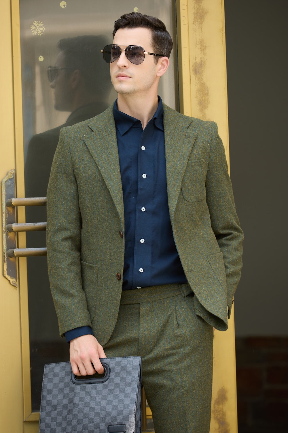 Close-up of green wool herringbone blazer paired with navy shirt for prom outfit