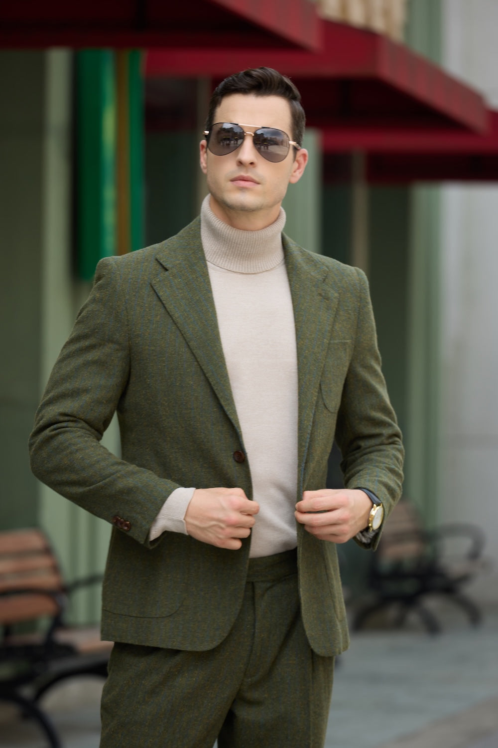 Green retro tweed suit styled with beige turtleneck for modern formal look