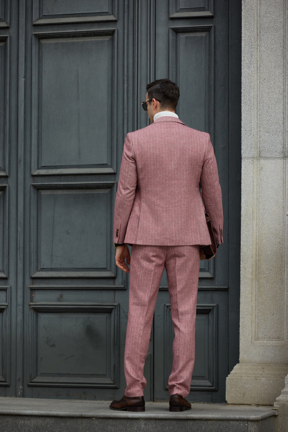 Back view of tailored red herringbone wool suit jacket and trousers
