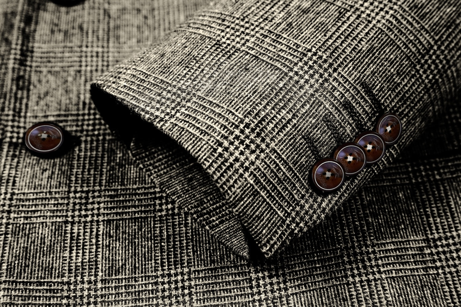 sleeve cuff detail of men's grey herringbone wool business suit