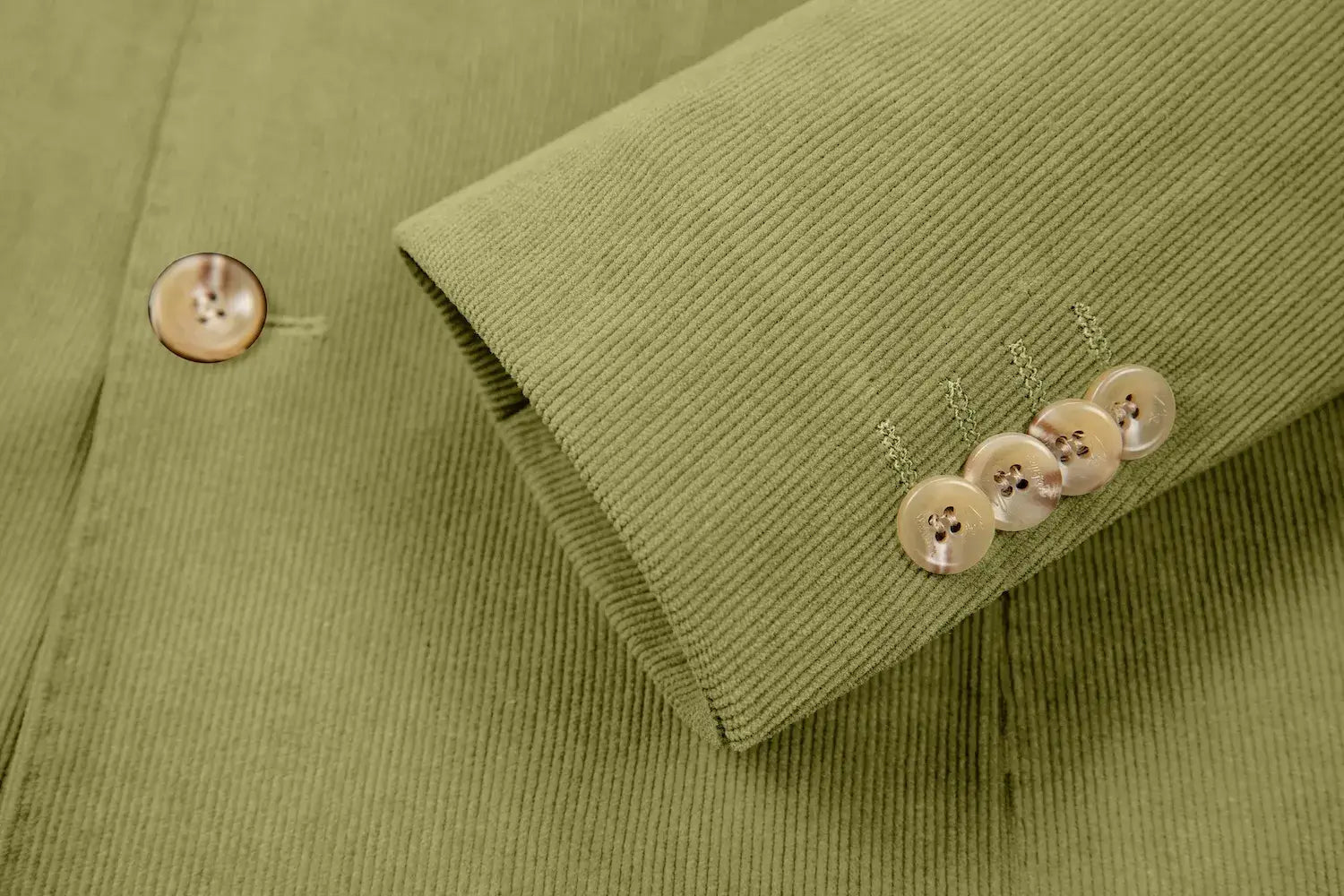 Detailed sleeve cuff of apple green corduroy blazer – buttoned and tailored