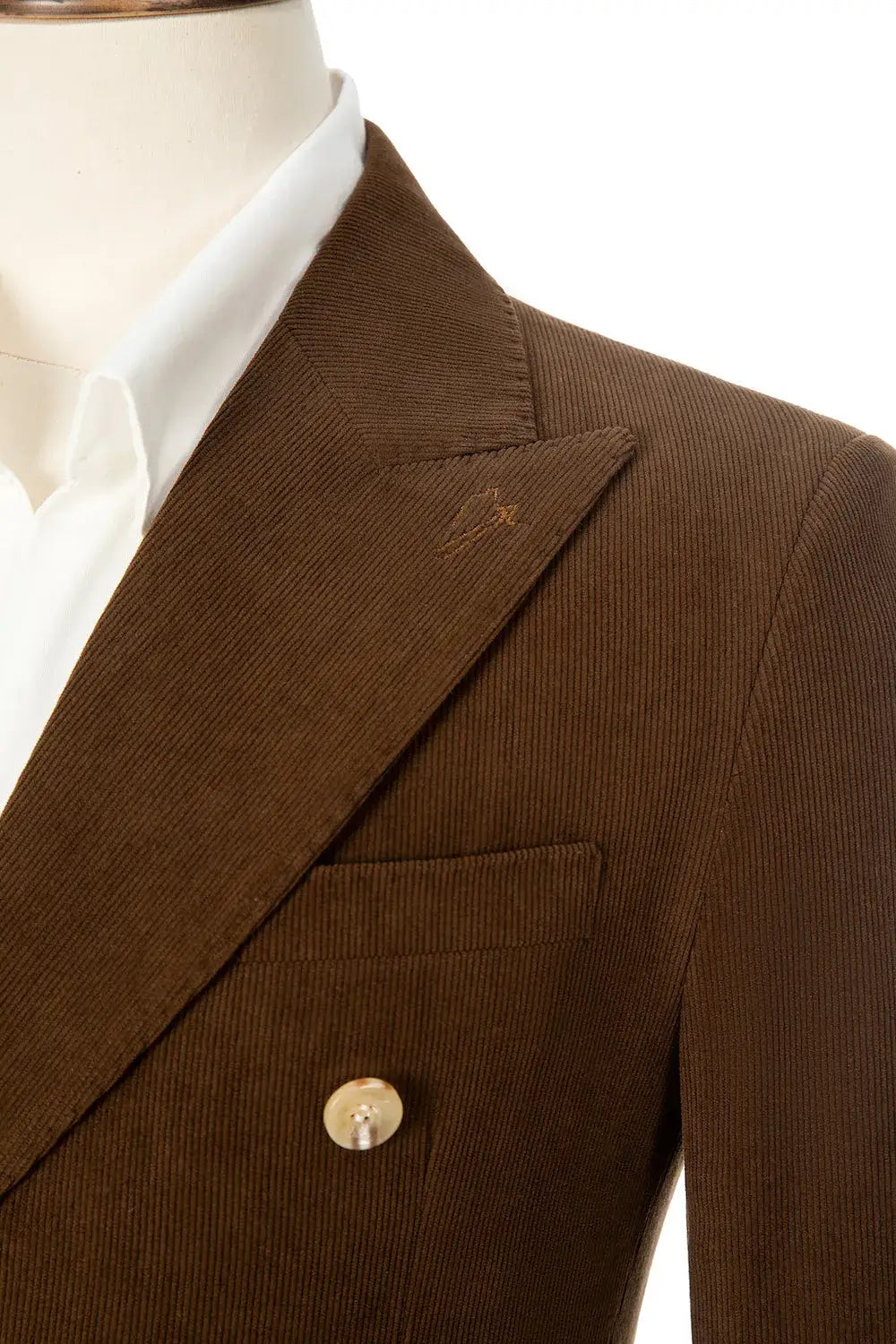 Close-up of corduroy blazer lapel and collar – peak lapel detail on brown double breasted jacket