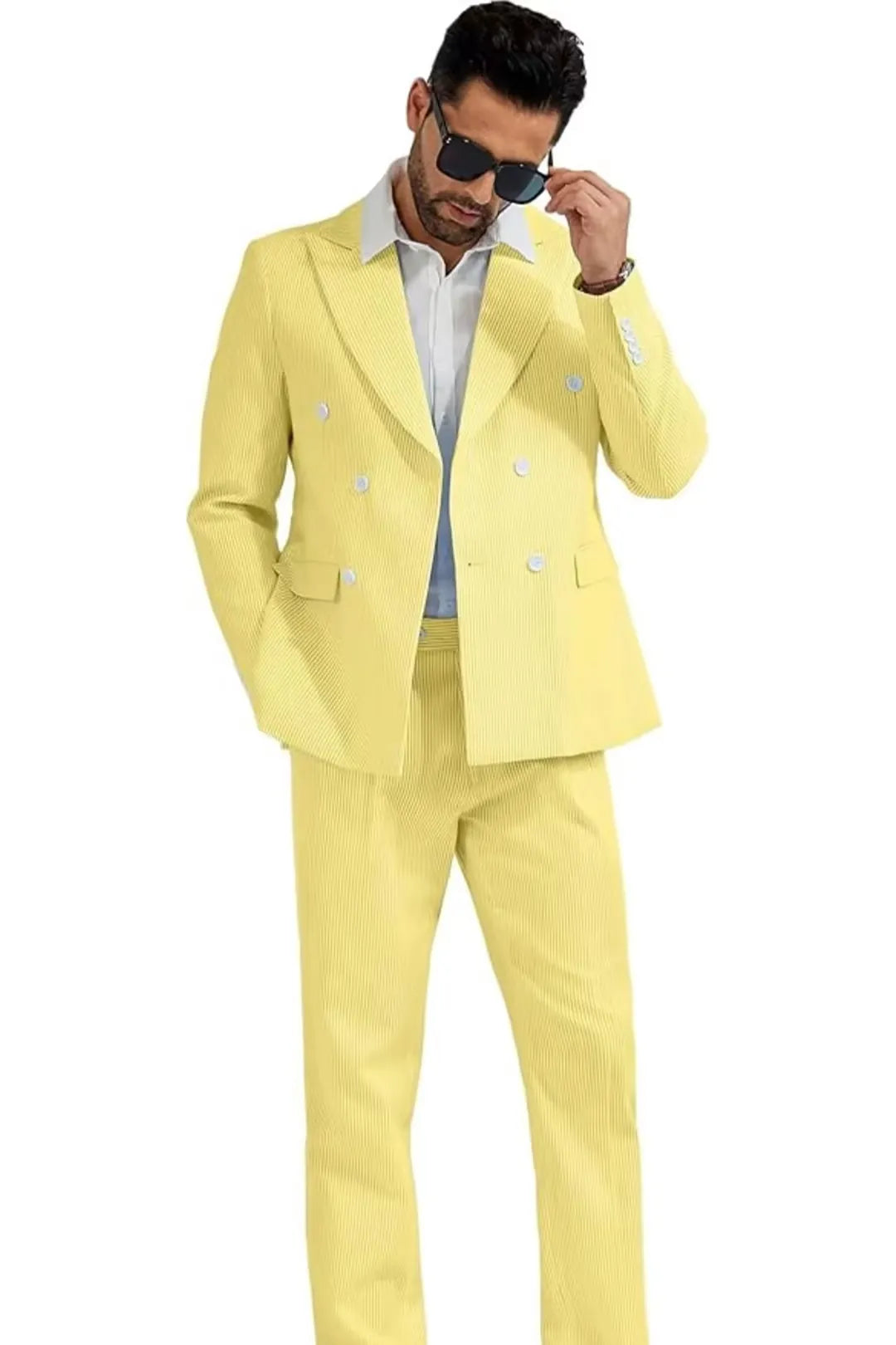 model wearing a yellow double-breasted seersucker suit with a modern fit, styled with a white shirt and sunglasses.